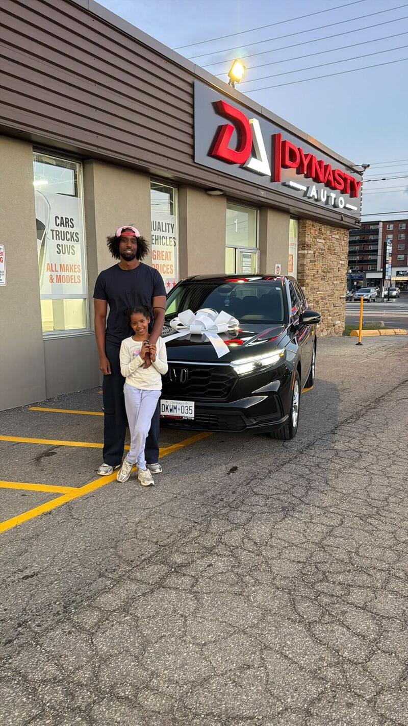 Customer and his daughter with their new black Honda CR-V