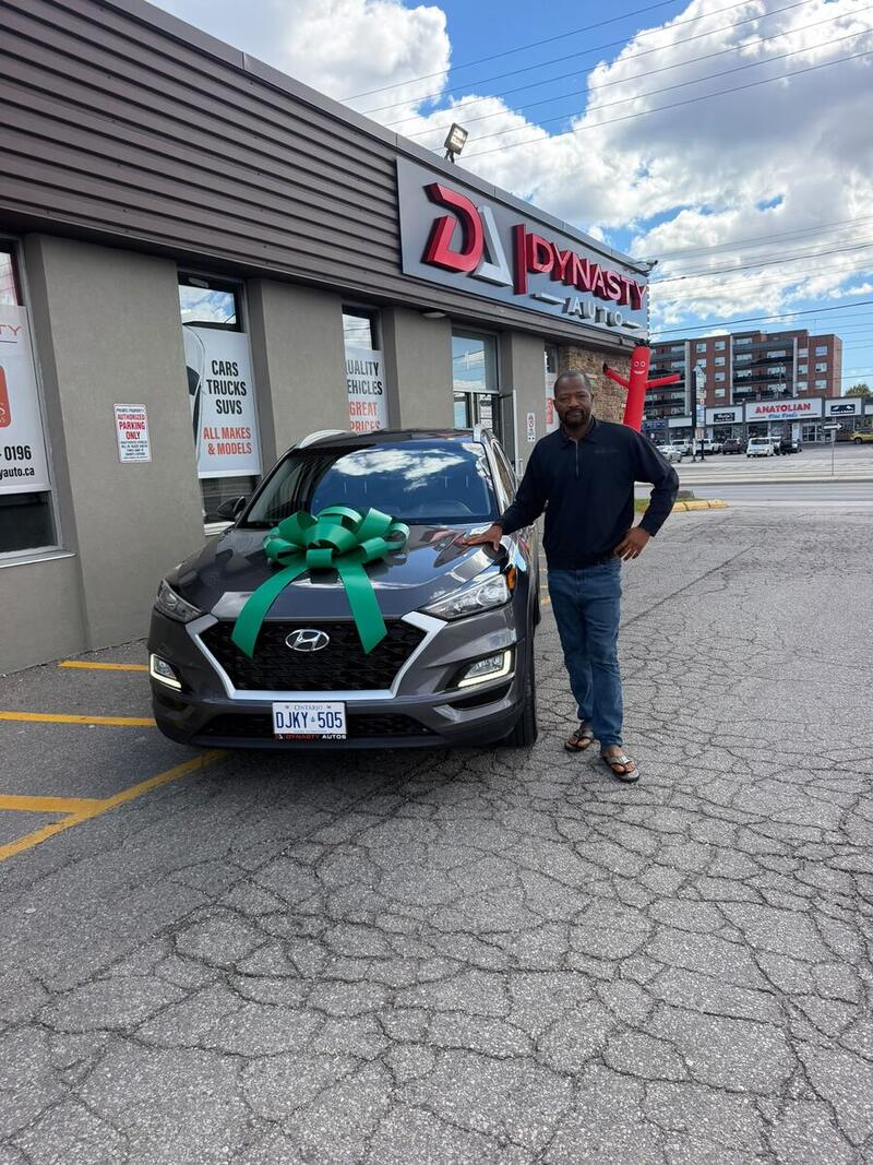 Customer with his new grey Hyundai Tucson
