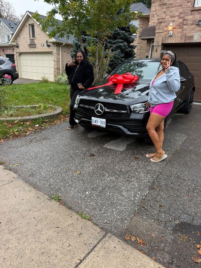 Two customers with their new black Mercedes-Benz GLC Coupe
