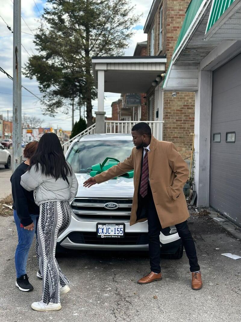 Customers receiving the keys to their white Ford Escape
